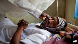 FILE - A patient with hepatitis is treated at a hospital in El Sereif village, North Darfur, Sudan, May 13, 2013.