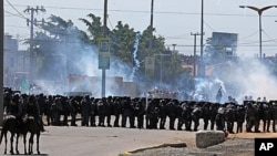 Riot police take position and fire tear gas at protesters gathering near Castelao stadium in Fortaleza, Brazil, June 19, 2013. 
