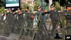 FILE - Riot police stand guard at a blocked street outside the Supreme Court in Phnom Penh, Cambodia, Nov. 16, 2017.