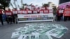 FILE - Fake bank notes bearing U.S. President Donald Trump’s image are displayed as protesters rally against the United States' demand for raising the defense costs for stationing U.S. troops in South Korea, near the U.S. embassy in Seoul, Oct. 22, 2019.