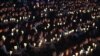 FILE – High school students in Ansan, South Korea, hold candles at a ceremony honoring victims of the Sewol ferry disaster two years earlier off the country’s southern coast.