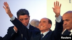 Forza Italia party leader Silvio Berlusconi waves as he leaves at the end of a rally in Catania, Italy, Nov. 2, 2017. 