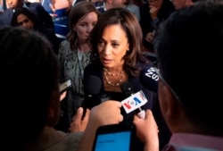 FILE - Democratic presidential hopeful Kamala Harris speaks to reporters after the second Democratic debate of the 2020 presidential campaign season in Miami, June 27, 2019.