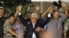 Palestinian President Mahmoud Abbas (C) holds hands with Palestinian prisoners who were released from Israeli prisons during celebrations in the West Bank city of Ramallah, Aug. 14, 2013.