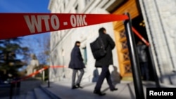 FILE - Delegates arrive at the World Trade Organization (WTO) headquarters in Geneva, Switzerland.