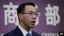 FILE - Chinese Ministry of Commerce spokesman Gao Feng speaks during a press conference at the Ministry of Commerce in Beijing, April 6, 2018.