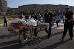 An ethnic Armenian soldier, who was wounded in fighting with Azeri forces over the breakaway region of Nagorno-Karabakh, is carried on a stretcher to Erebouni Medical Center in Yerevan, Armenia, Sept. 29, 2020. (Credit: Hakob Margaryan/Photolure)