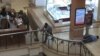 An image grab taken from AFP TV shows Kenyan troops taking position on September 21, 2013 inside the Westgate mall in Nairobi as a victim (R) lies on the ground.
