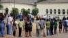 FILE - Voters line up to cast their votes at a polling station, in Maputo, Mozambique, Oct. 15, 2014.