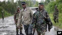 Congolese M23 rebel soldiers are seen on the road to Rushuru near Buhumba some 25 kilometers (16 miles) north of Goma, November 22, 2012. 
