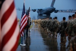 US Army paratroopers prepare equipment and load aircraft at Fort Bragg, N.C. on Jan. 4, 2020. This Pentagon said their deployment is a response to increased threats against US personnel and facilities.