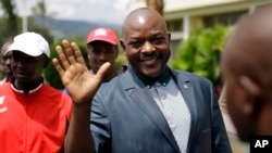 FILE - Burundi President Pierre Nkurunziza waves as he walks to his car after making a brief statement to the media at the presidential palace in Bujumbura, Burundi, May 17, 2015. 