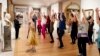 FILE - An exercise group works in front of a bust of Benjamin Franklin at the Metropolitan Museum of Art in New York, Feb. 10, 2017. 