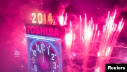 Fireworks explode past the Times Square Ball after it dropped to signal the start of the new year in Times Square, Midtown, New York January 1, 2014. REUTERS/Adrees Latif (UNITED STATES - Tags: SOCIETY) - RTX16YQG