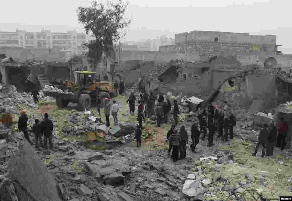 Civilians gather after what they said was shelling by forces loyal to Syrian President Bashar al-Assad, Jazmati, Aleppo, Jan. 23, 2014.