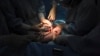 FILE - A doctor cuts the umbilical cord of a newborn baby.