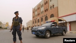 A pro-Houthi police trooper stands past a patrol vehicle in the Red Sea port city of Hodeidah, Yemen, June 14, 2018. 