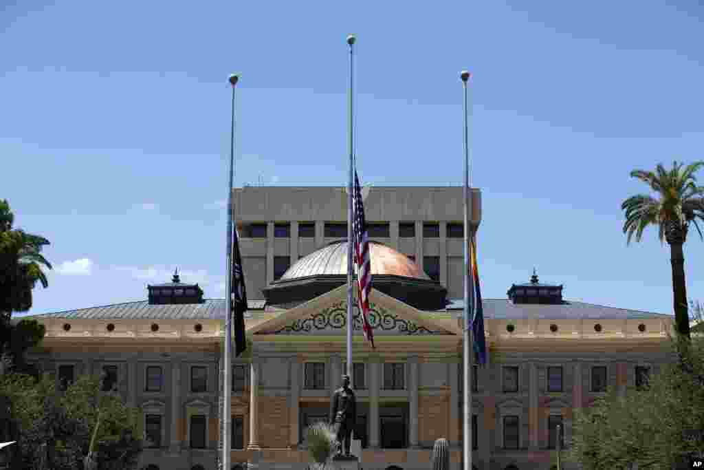 Flags fly at half-staff at the Arizona Capitol in memory of the late Arizona Republican Sen. John McCain, Aug. 26, 2018, in Phoenix.