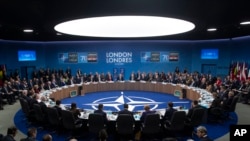 NATO Secretary General Jens Stoltenberg makes an opening statement during a plenary session at the NATO summit at The Grove, Dec. 4, 2019, in Watford, England. 