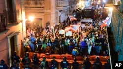 Demonstrators protest against governor Ricardo Rossello, in San Juan, Puerto Rico, July 19, 2019. Protesters are demanding Rossello step down for his involvement in a private chat in which he used profanities.