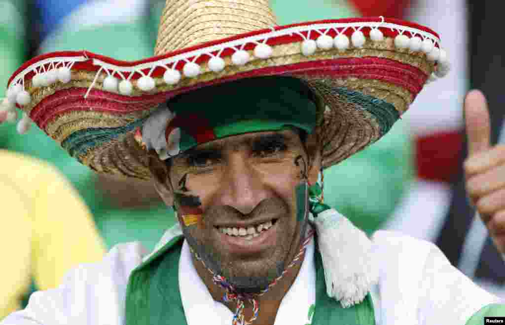 An Algerian fan smiles for the camera before the match between Germany and Algeria, at the Beira Rio stadium, in Porto Alegre, June 30, 2014.