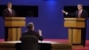 Moderator Jim Lehrer tells Republican presidential candidate Texas Gov. George W. Bush, right, that the candidates made the rules as Democratic presidential candidate Vice President Al Gore listens at the first presidential debate Tuesday, Oct. 3, 2000, a