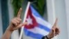 Los manifestantes realizan la letra "L", por la libertad y ondean banderas, el 14 de julio de 2021, en el barrio de La Pequeña Habana de Miami, Estados Unidos.
