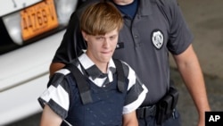 FILE - In this June 18, 2015 file photo, Charleston, S.C., shooting suspect Dylann Storm Roof is escorted from the Cleveland County Courthouse in Shelby, N.C. 