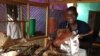 Restaurant owner, Bella Tandina, Dr. One Close, credits the success of his rotisserie to the superior quality of his cooking, his upbeat disposition, witty repartee with customers, which he calls his one-man marketing efforts, (Anne Look/VOA)