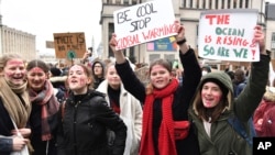 Students and others hold up placards with climate messages during a demonstration against climate change in Brussels, Thursday, Jan. 17, 2019. (AP Photo/Geert Vanden Wijngaert)