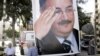 A memorial poster of Brig. Gen. Wissam al-Hassan, who was assassinated Friday, hangs near the spot Friday's car bomb attack that killed Al-Hassan, in the Achrafiye district of Beirut, Lebanon, October 23, 2012.