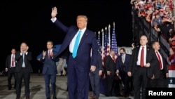 President Donald Trump waves before boarding Air Force One for a trip to Charlotte, NC, to deliver remarks on health care, Sept. 24, 2020, in Andrews Air Force Base, Md. 