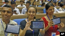 Students in in New Delhi, India, display Aakash, which means "sky" in Hindi. It is called the world's cheapest tablet computer. (2011 FILE PHOTO)