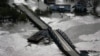 A barge damages a bridge that divides Lafitte, La., and Jean Lafitte, in the aftermath of Hurricane Ida, Aug. 30, 2021, in Lafitte, La.
