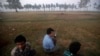 Men displaced by the recent violence in Pauktaw listen to morning news on a portable radio at Owntaw refugee camp for Muslims outside Sittwe November 1, 2012. U.N. human rights investigators called on Myanmar on Wednesday to halt deadly sectarian violence