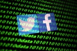 FILE - The Twitter and Facebook logos are seen with binary cyber codes in this illustration, Nov. 26, 2019.