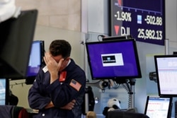Trader James Coffey works on the floor of the New York Stock Exchange, Aug. 5, 2019.