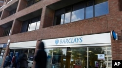 Pedestrians pass a branch of Barclays Bank in Swiss Cottage in London, Sept. 20, 2013.