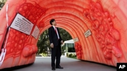 Assemblyman Richard Pan, D-Sacramento, who is pediatrician, passes through an inflatable colon display in Sacramento, Calif., March 24, 2014. The display shows what a healthy colon looks like, how polyps develop and how they can turn cancerous. 