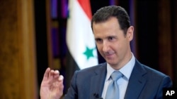 FILE - Syrian President Bashar Assad gives an interview with the BBC in Damascus, Syria. (Photo released by official Syrian news agency SANA)