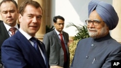 Russian President Dmitry Medvedev, left, and Indian Prime Minister Manmohan Singh shake hands before talks in New Delhi, 21 Dec 2010