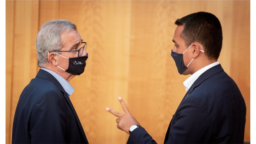 FILE - Malta's Foreign Minister Evarist Bartolo and his Italian counterpart Luigi Di Maio wear protective masks as they talk to each other during the EU foreign ministers' meeting in Berlin, Germany, Aug. 27, 2020. (Kay Nietfeld/Pool via Reuters)