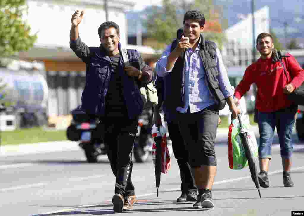 Migrants walk towards Germany at the border crossing with Austria in Freilassing, Germany. Germany cut its train link with the Austrian city of Salzburg, shutting down the main route into its territory for tens of thousands of people caught in Europe's worst migration crisis in decades.