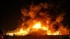 FILE - A picture taken late June 2, 2021, shows Iranian firefighters trying to extinguish an oil refinery blaze in Tehran. Other oil facility fires were reported in the Ahvaz region later in the week.