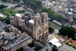 This aerial picture taken on June 12, 2019 in the French capital Paris shows the Notre Dame de Paris cathedral under repair after it was badly damaged by a huge fire on April 15.
