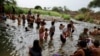Migrants traveling in a caravan to reach the US border through Mexico rest in Mapastepec, Mexico, Dec. 29, 2023.