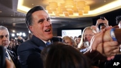 Republican presidential candidate, former Massachusetts Gov. Mitt Romney, greet supporters at his Super Tuesday primary night rally in Boston, Tuesday, March 6, 2012. 