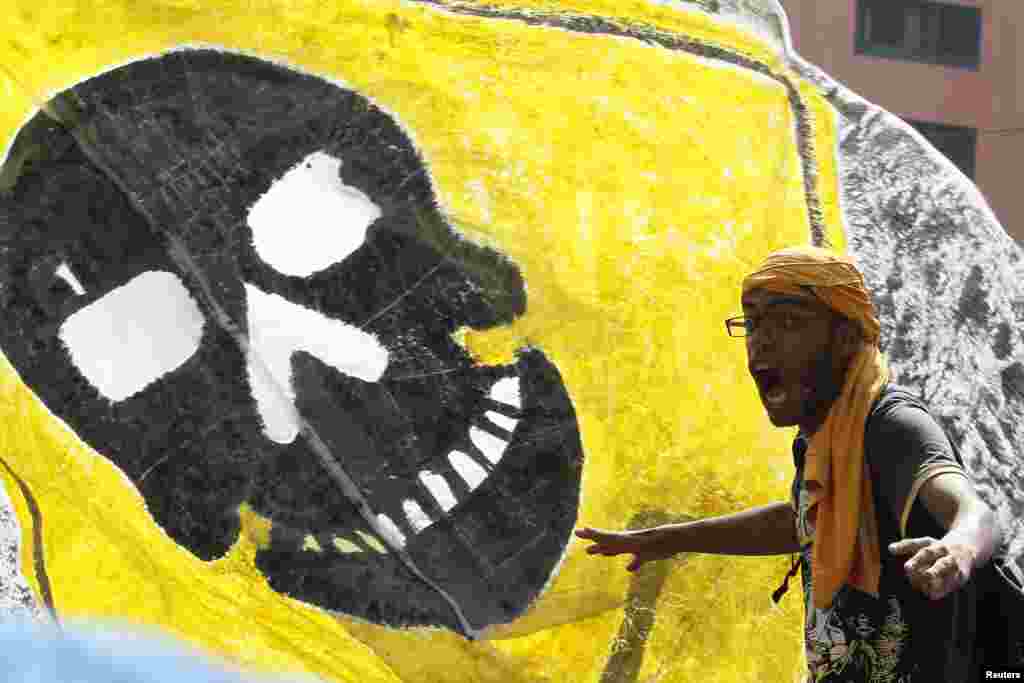 A supporter of deposed Egyptian President Mohamed Morsi shouts slogans during a protest outside Al-Fath Mosque in Ramses Square, Cairo, August 16, 2013.