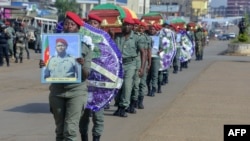 FILE - Soldiers carry the coffins of the four soldiers killed in the violence that erupted in the Northwest and Southwest Regions of Cameroon, during a ceremony in Bamenda, Nov. 17, 2017. 