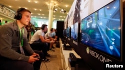 A gamer plays "Call of Duty: Advanced Warfare" on an Xbox One console during the Xbox Play Day 2014, before the Gamescom 2014 fair in Cologne August 12, 2014. The Gamescom convention, Europe's largest video games trade fair, is opened to the public from A